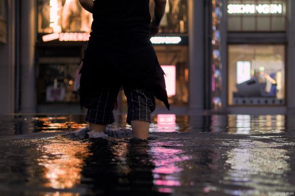 Not very sober man cooling his feet in a fountain - August